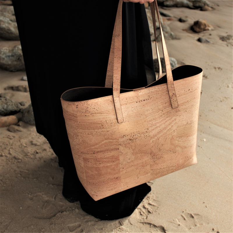 model with cork handbag on the beach